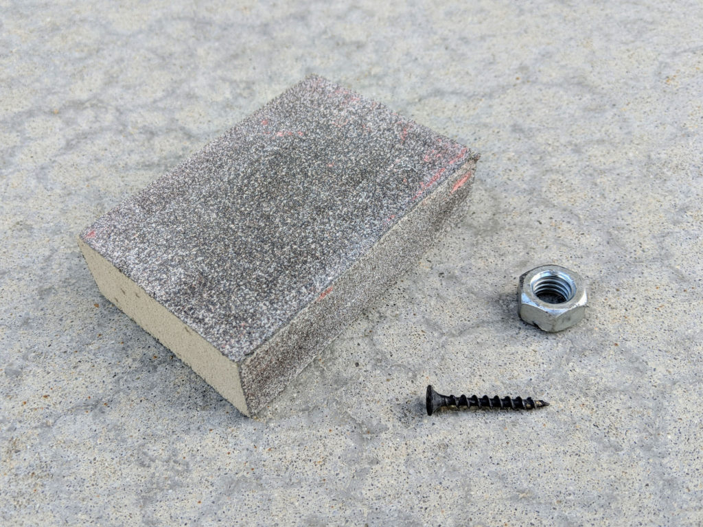 Sanding block, nut, and a screw