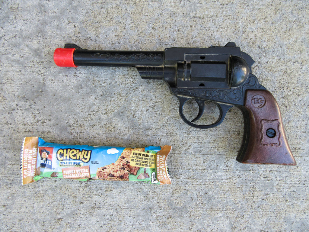 Plastic toy gun and a Quaker Chewy granola bar
