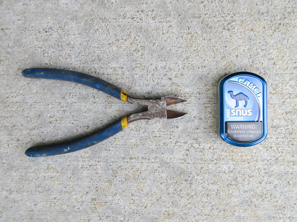 Wire cutters and a Camel snus tin