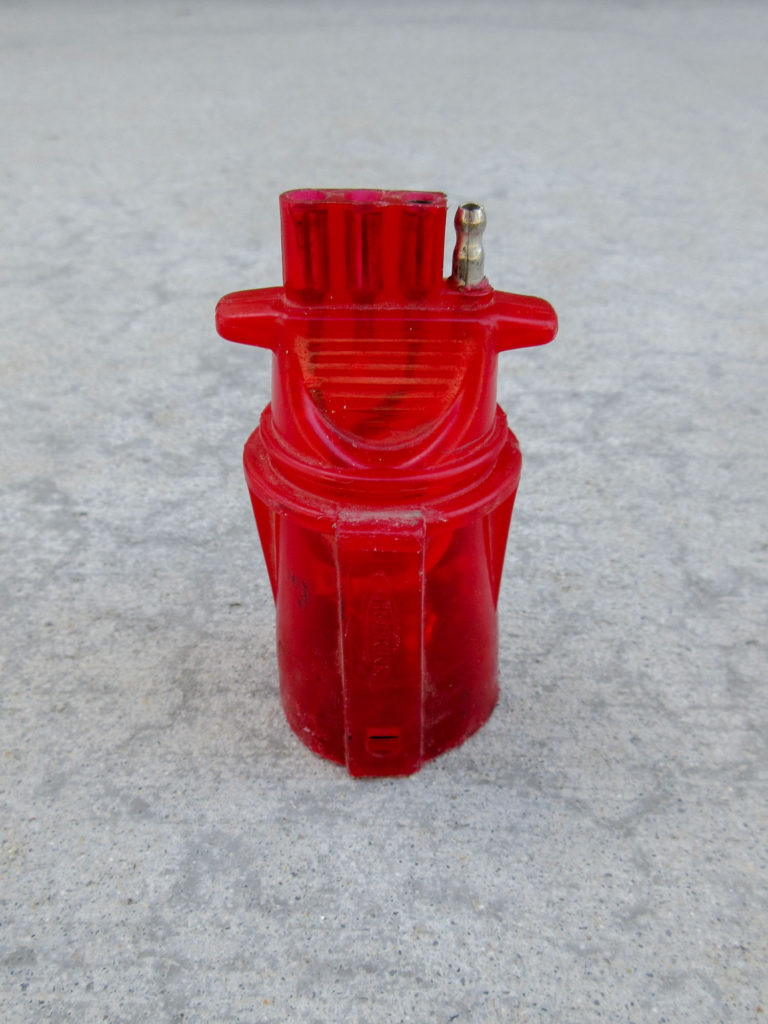 Clear, red plastic trailer wiring adapter
