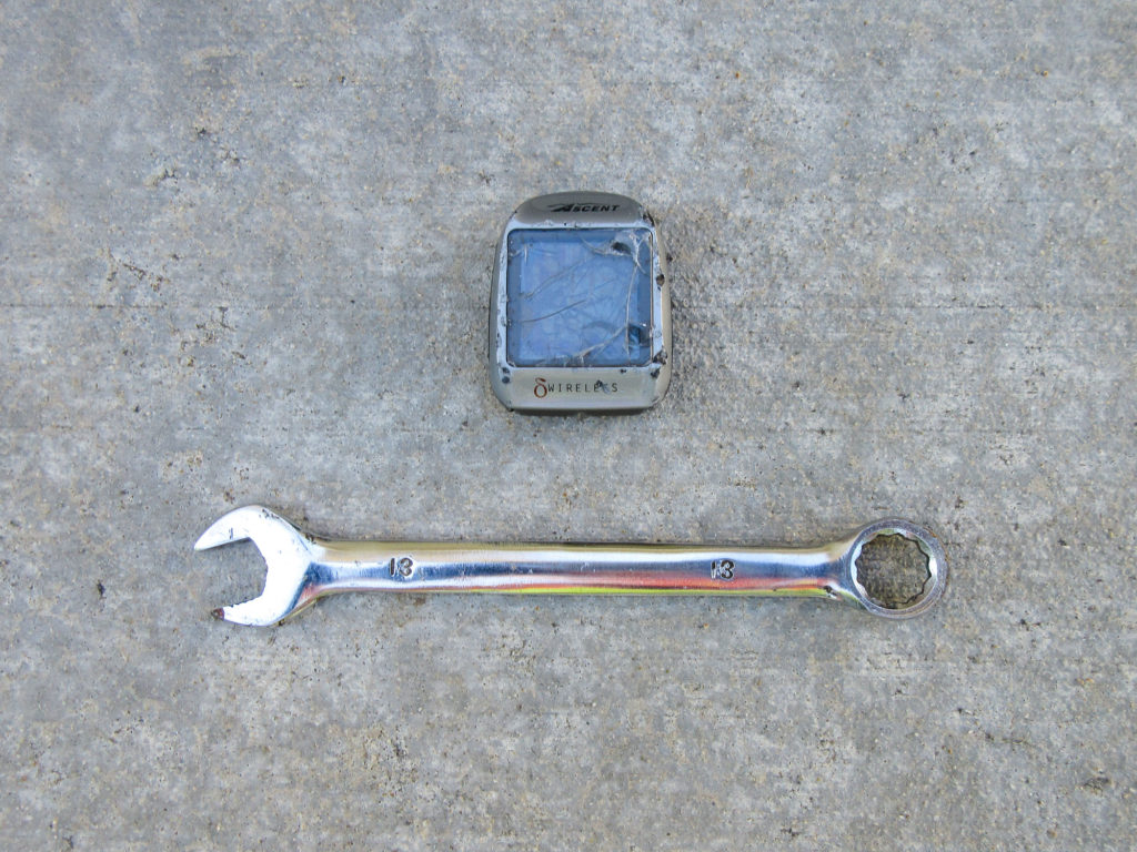 Battered Ascent wireless bicycle computer and 13mm open end wrench