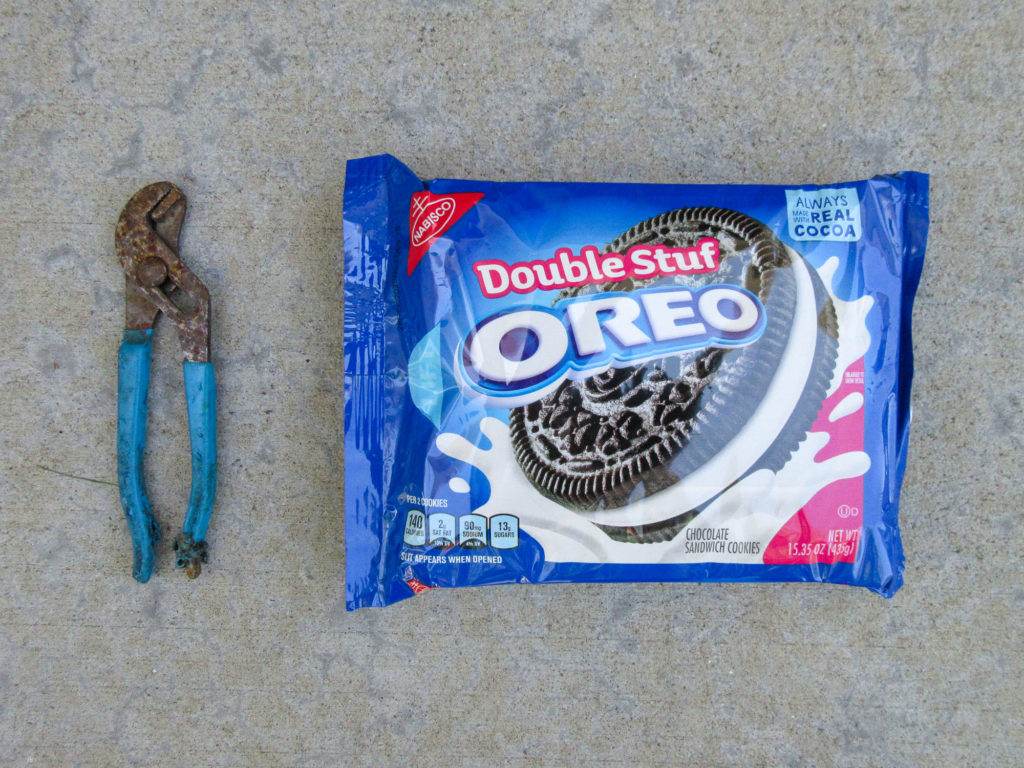 Rusty channel-lock pliers adn a package of Oreo Double Stuf cookies