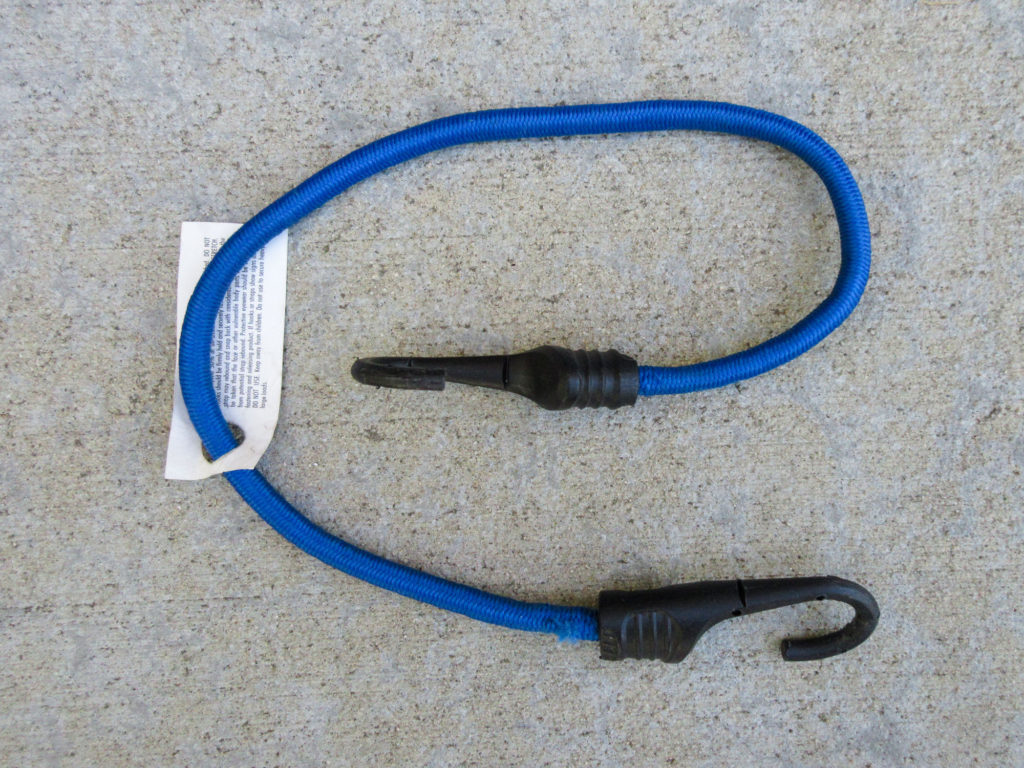 Blue bungee cord with safety tag still attached