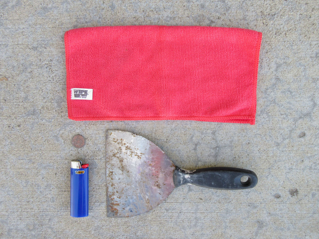 Red microfiber cloth, penny, blue BIC ligher and a putty scraper