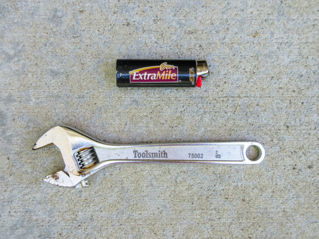 Black BIC lighter and Toolsmith 8" crescent wrench