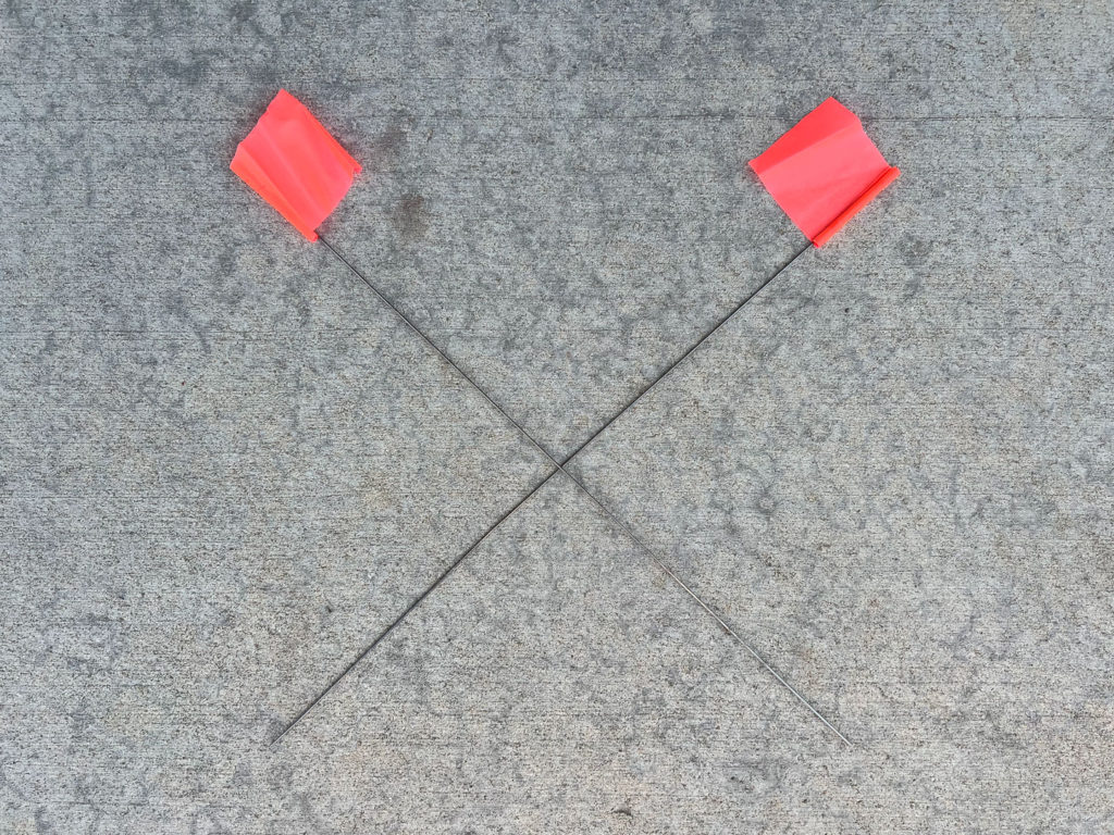 Two fluorescent pink landscape marking flags.