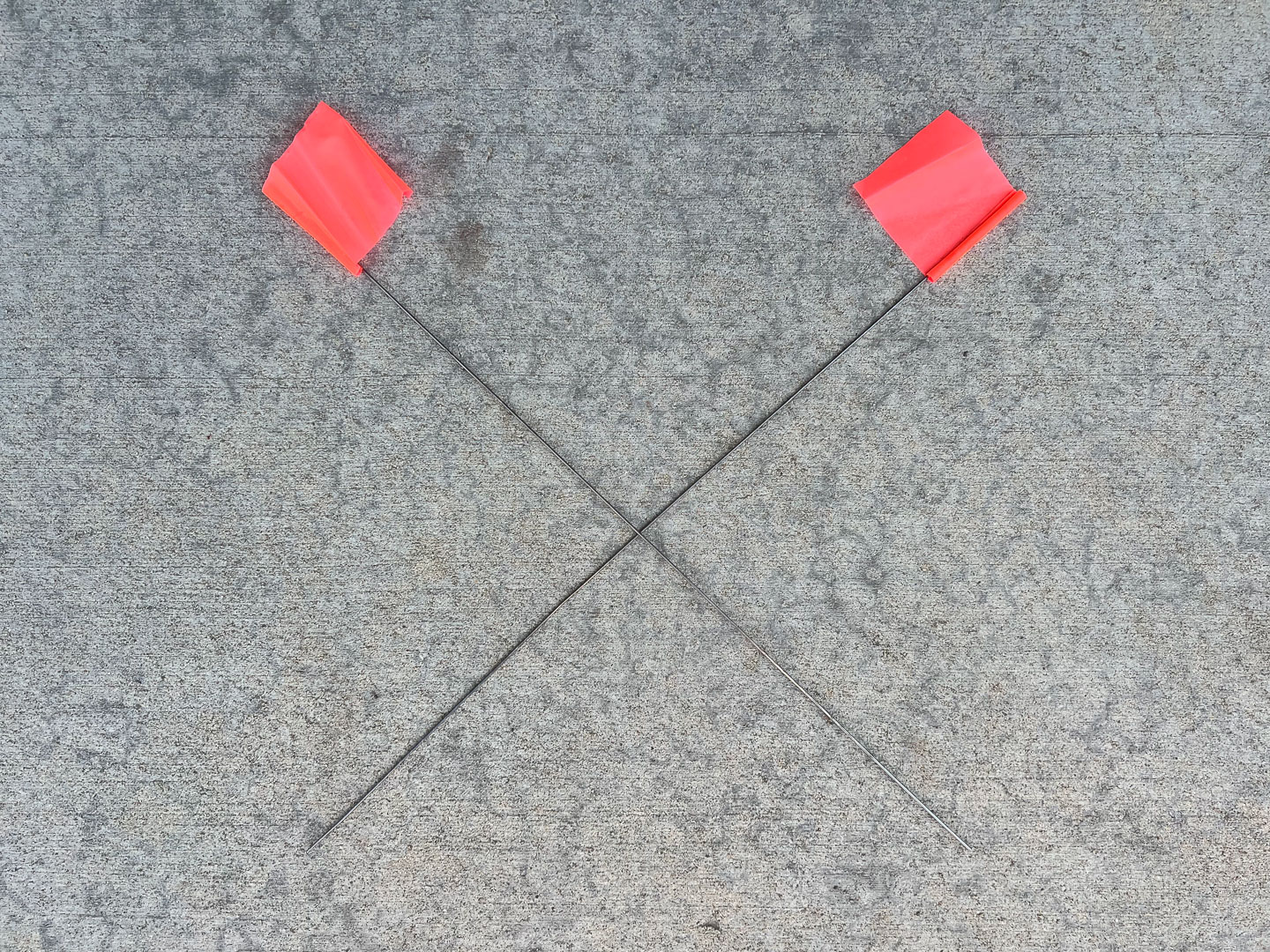 Two fluorescent pink landscape marking flags.