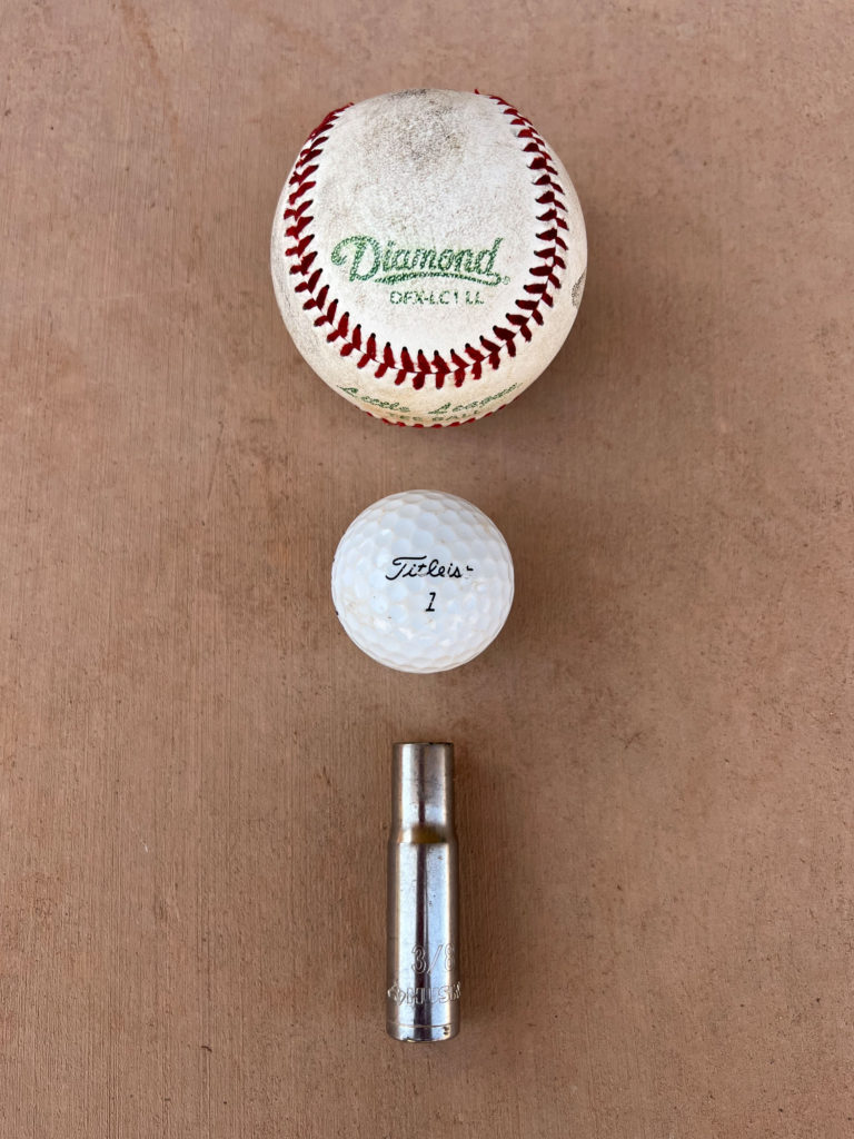 Baseball, golf ball, and 3/4" deep socket.