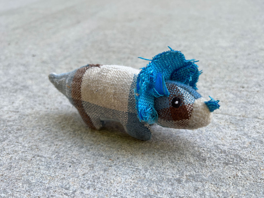 Blue and white triceratops doll