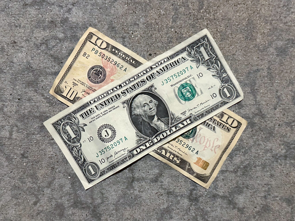 A ten-dollar bill and a one-dollar bill