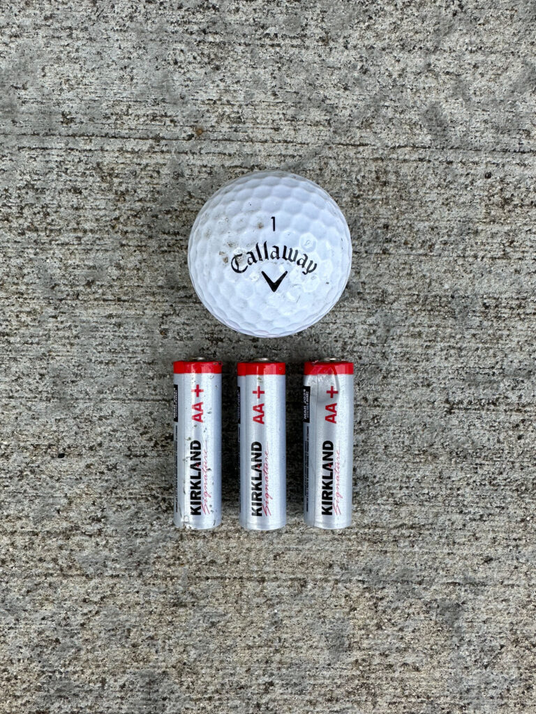 One Callaway golf ball and three Kirkland AA batteries
