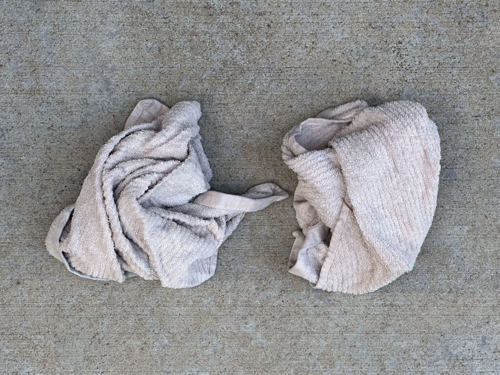 Two dirty, balled-up kitchen towels