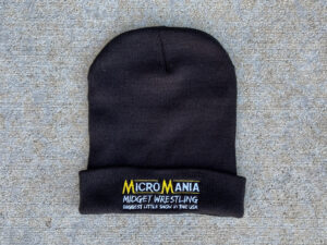 Black winter hat embroidered with "Micro Mania, Midget Wrestling, Biggest Little Show in the USA"